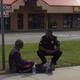Police Cpl. Brandon Lord offers assistance to an unidentified man seated on the roadside.
Philip Soukup via Facebook